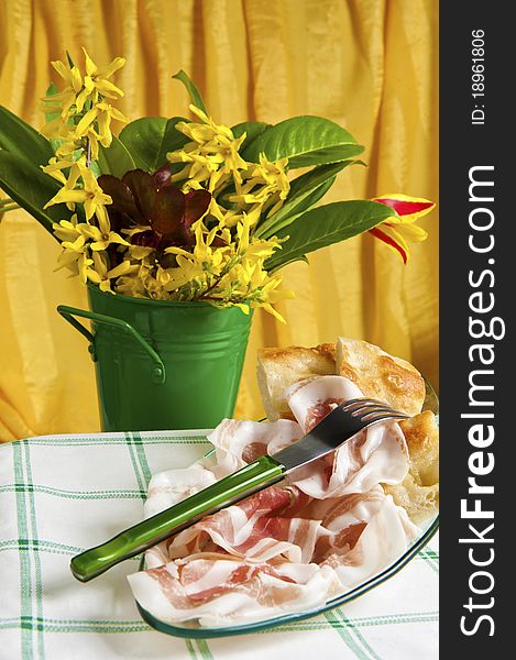 Typical Italian sausage sliced â€‹â€‹cake and flowers. Typical Italian sausage sliced â€‹â€‹cake and flowers