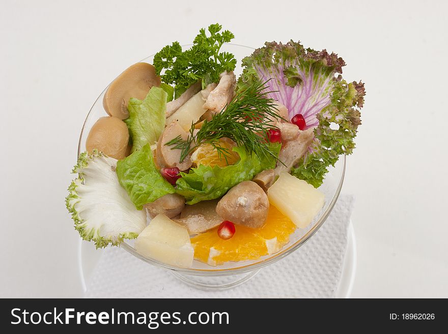 Salad with fruits and greens, studio isolated shot