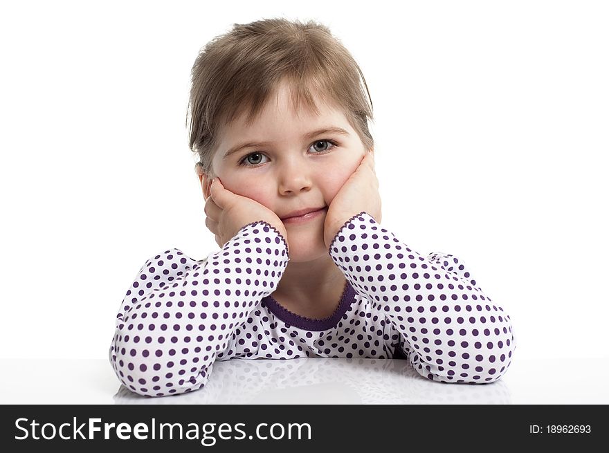 Little girl set her elbows against the desk. Little girl set her elbows against the desk