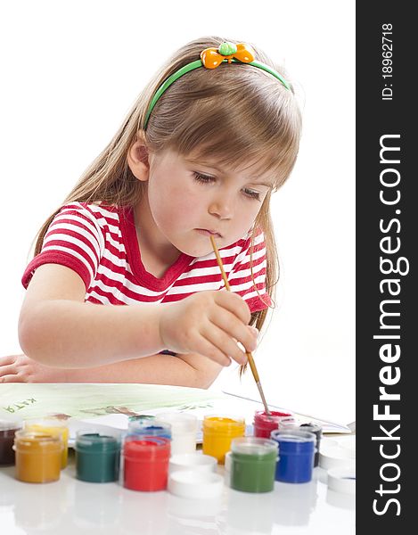 Little girl is drawing with different colors