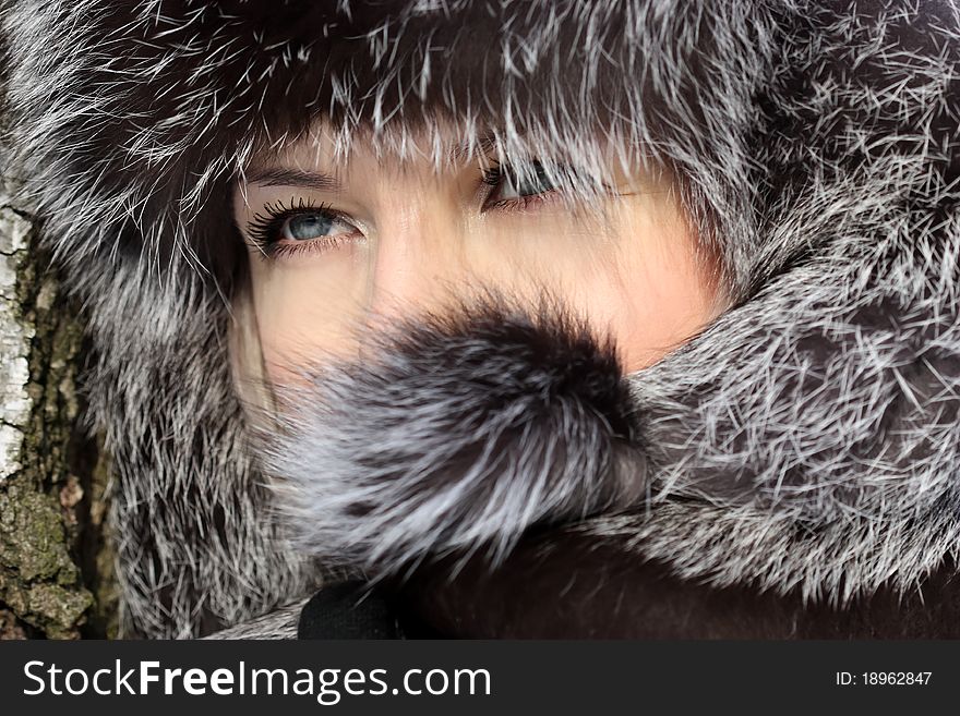 Beautiful woman in winter fur coat