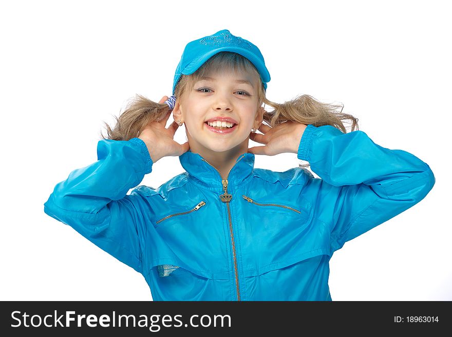 Portrait of a cute young girl standing on the blue cap and sport clothe with heaved up hands at a head over white background. Portrait of a cute young girl standing on the blue cap and sport clothe with heaved up hands at a head over white background