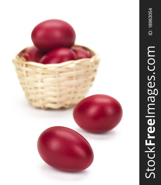 A close up of two red eggs out of a wicked basket. A close up of two red eggs out of a wicked basket