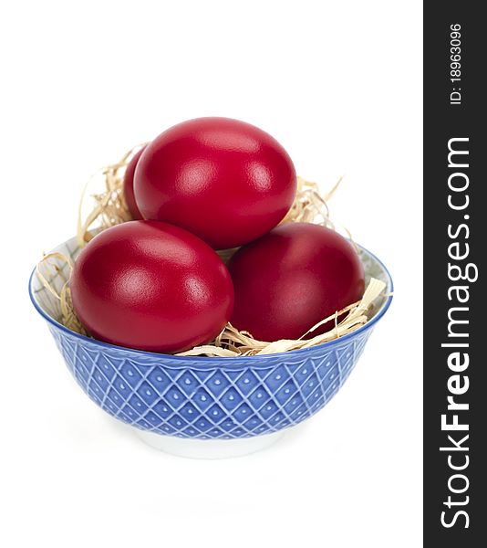 Red eggs in a blue and white porcelain bowl. Red eggs in a blue and white porcelain bowl