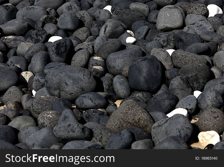 One white stone standing out among gray ones