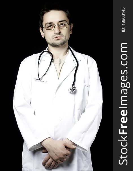 Doctor posing on black background