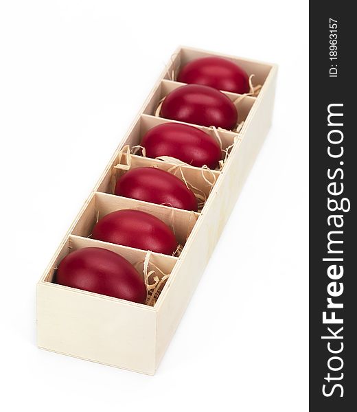 Red eggs in a wooden box with  a foreground view. Red eggs in a wooden box with  a foreground view