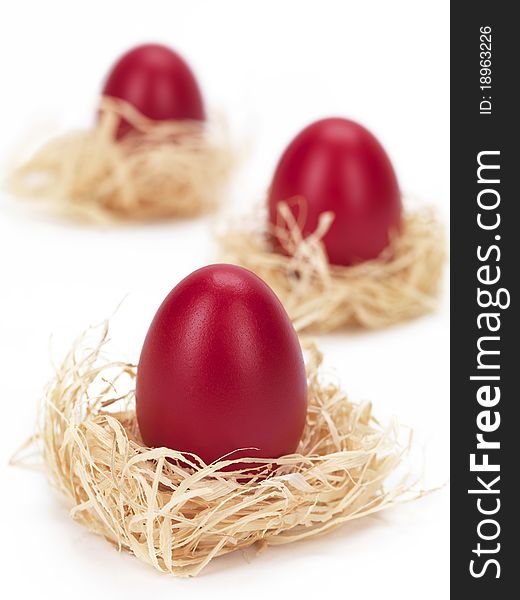 Red eggs in grass nests for easter decoration. Red eggs in grass nests for easter decoration