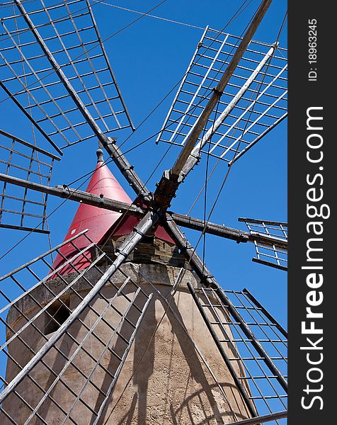 Ancient windmill located close to the saline in trapani. Ancient windmill located close to the saline in trapani