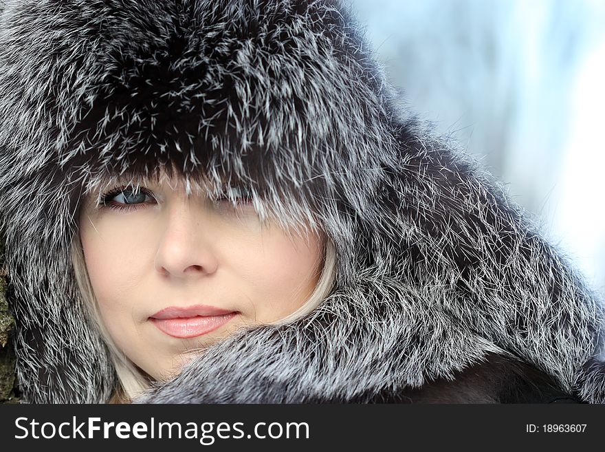 Beautiful woman in winter fur coat