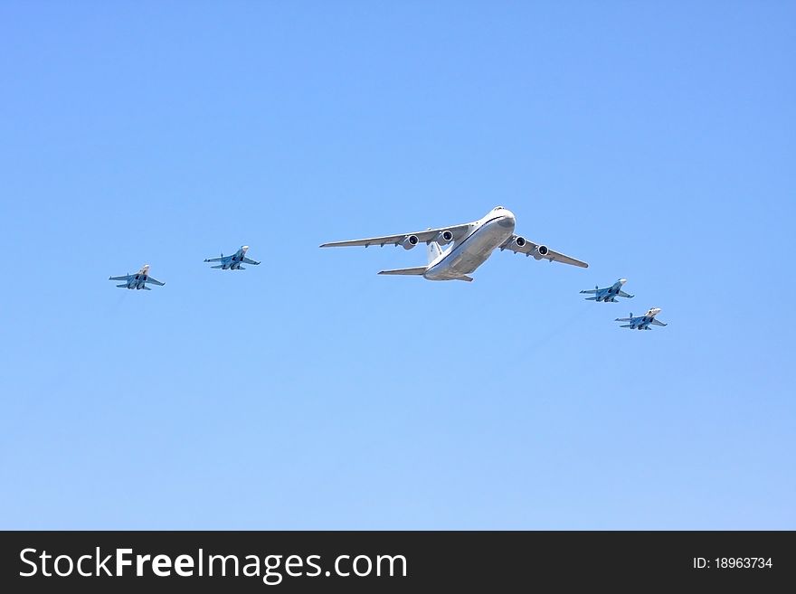 The Transport Plane Accompanied By Fighters