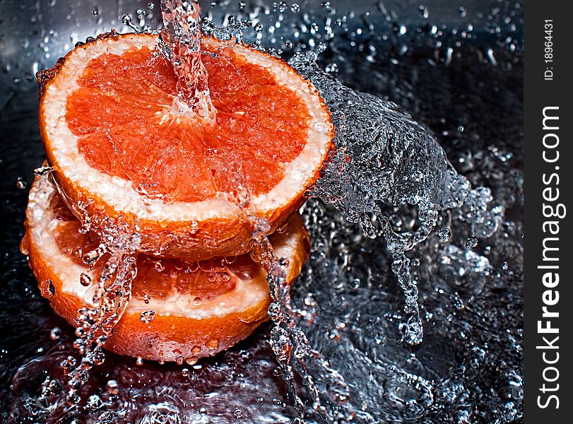 Water splashing over two oranges. Water splashing over two oranges
