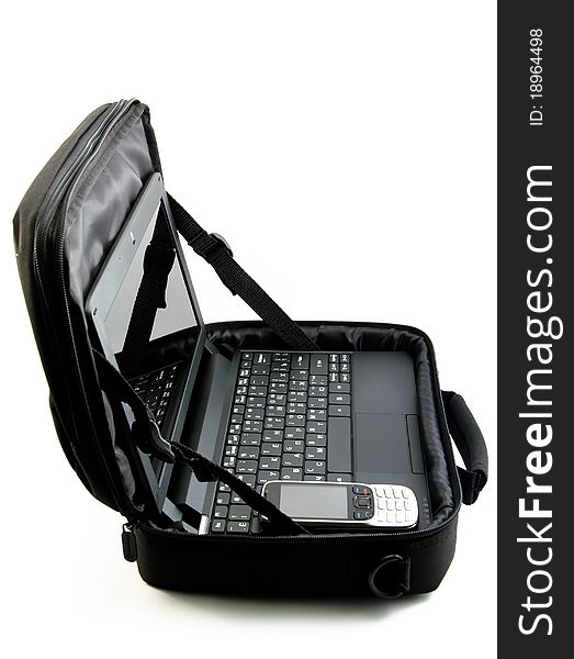 The laptop lies in an open bag together with phone. The laptop lies in an open bag together with phone
