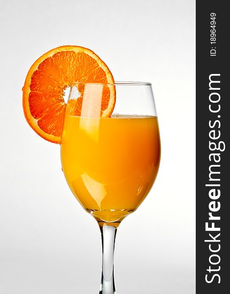 Squeezing orange into a glass of juice. Squeezing orange into a glass of juice
