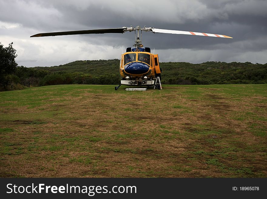 Helicopter stationary and landed on grass space. Helicopter stationary and landed on grass space.