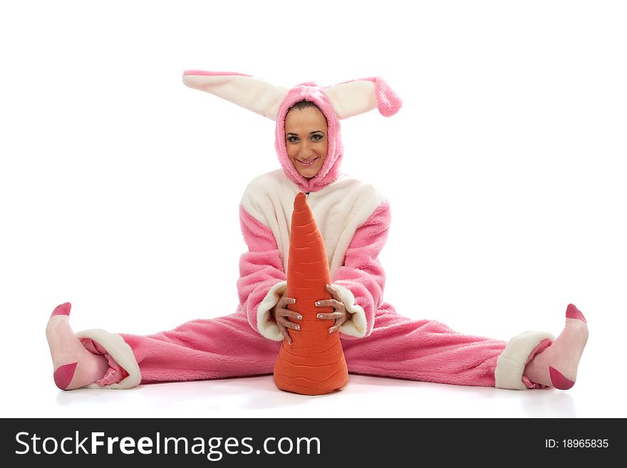 Funny pink rabbit with big carrot isolated on white background
