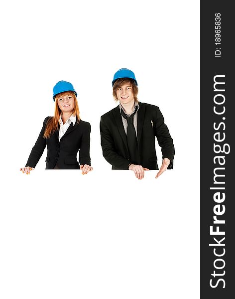 Business man and business woman holding board with helmets on over white background. Business man and business woman holding board with helmets on over white background