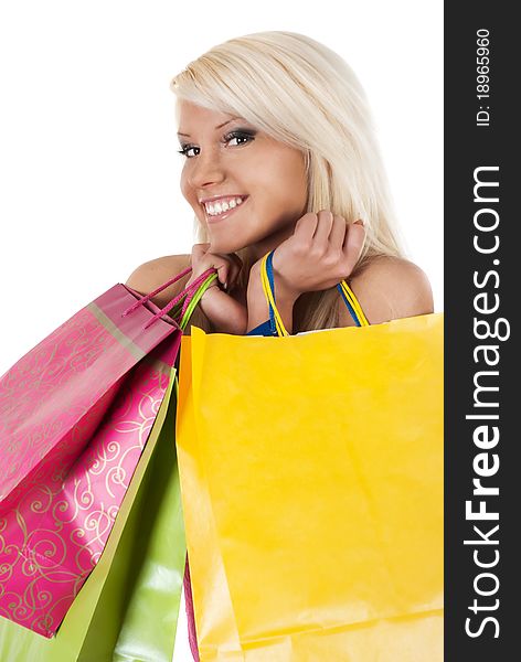 Portrait of stunning young woman carrying shopping bags against white background