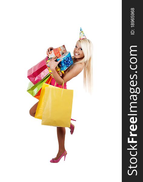 Young beautiful woman carryin birthday gifts and shopping bags over white background