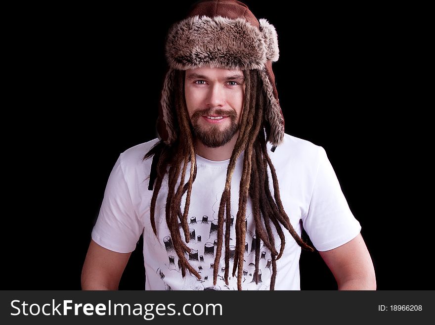Guy with dreadlocks wearing a fur hat