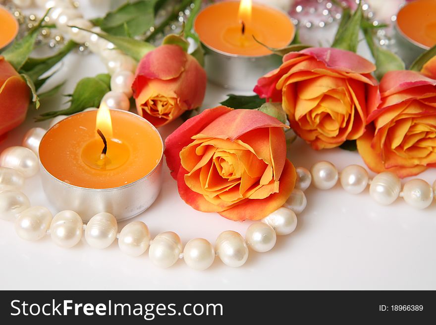 Fine roses and burning candles. Fine roses and burning candles
