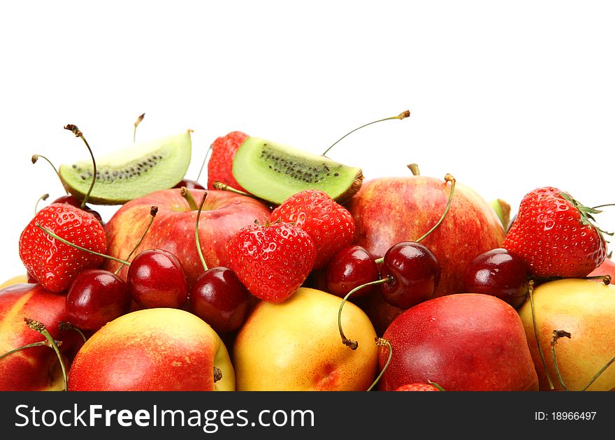 Ripe fruit and berries on a white background