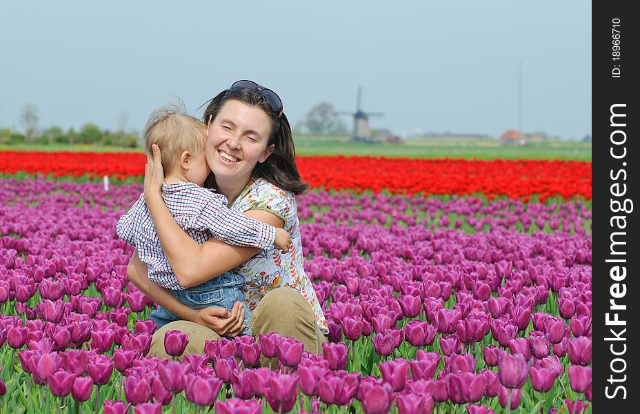 Mother with son in the purple tulips field. Mother with son in the purple tulips field