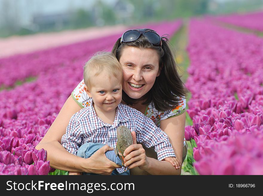 In Tulip Field. Mother with son in tulips field