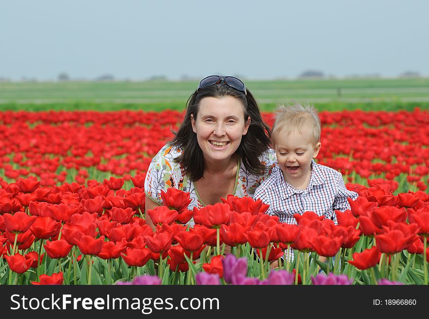 In Tulip Field. Mother with son in tulips field