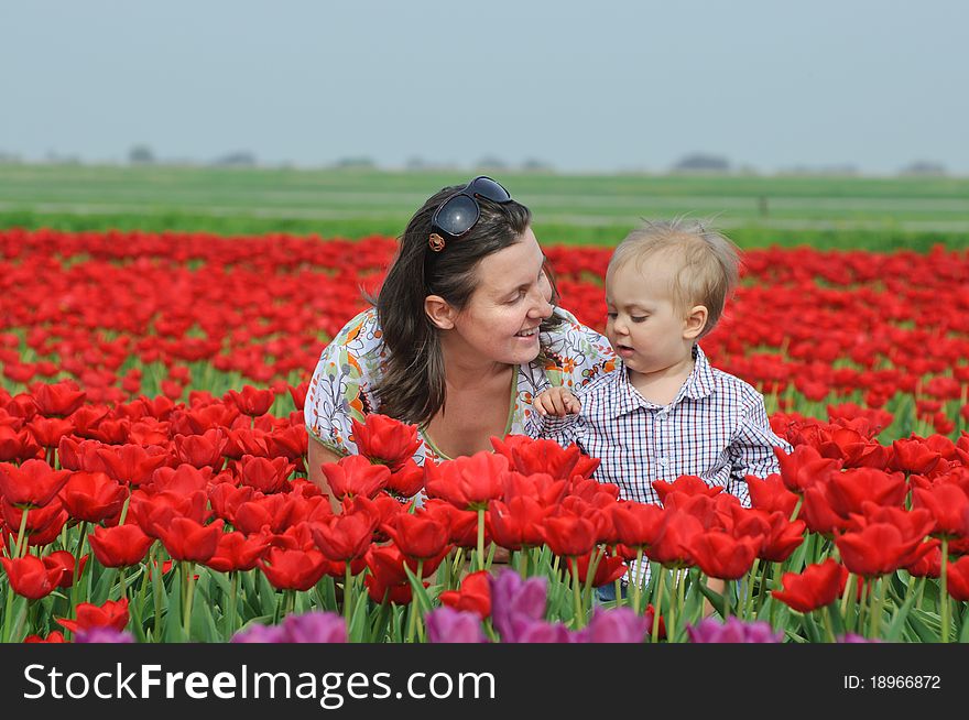 Mother with son in the red tulips field. Mother with son in the red tulips field