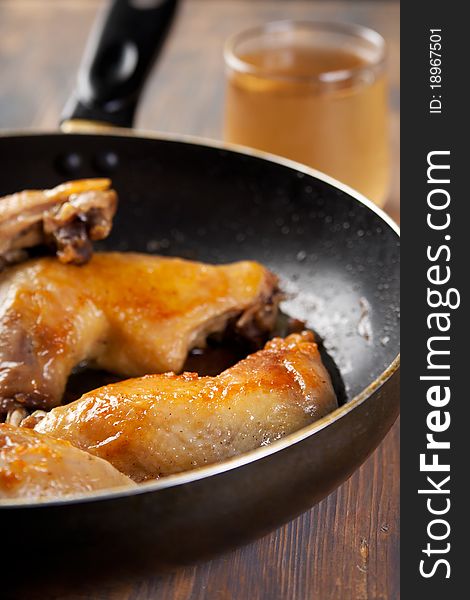 Golden chicken legs fried in a non stick pan