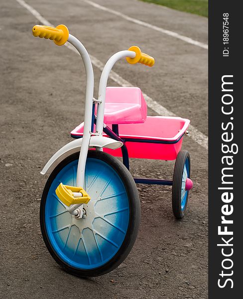 Children's tricycle, standing on the pavement