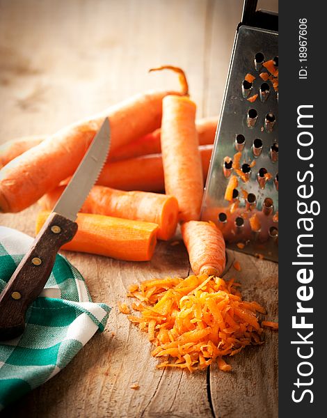 Carrot, peel and knife on a rustic table. Carrot, peel and knife on a rustic table