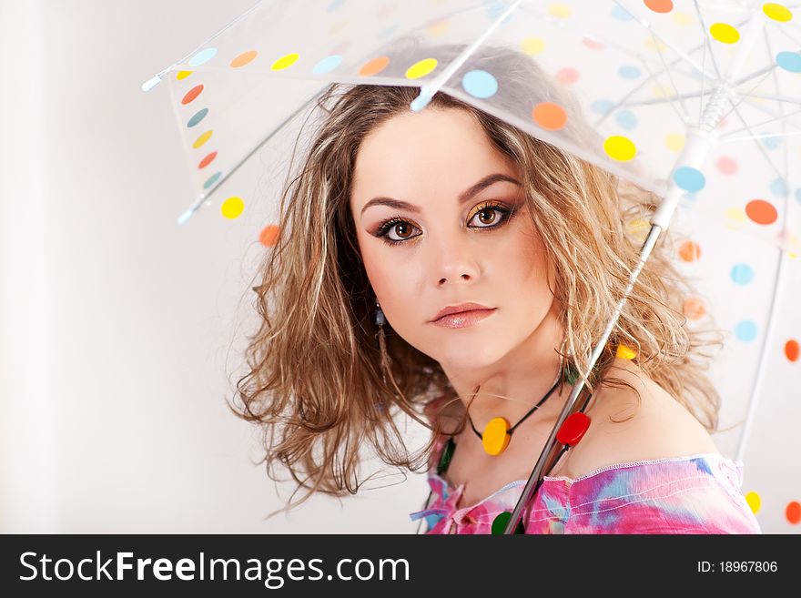 Beautifull girl under polka dotted umbrella