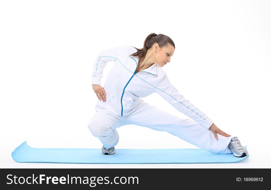 Woman doing stretching on a mat. Woman doing stretching on a mat