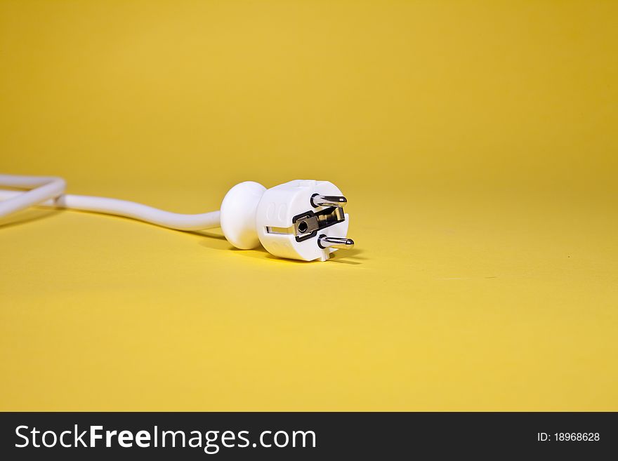 White power cable with plug on yellow background