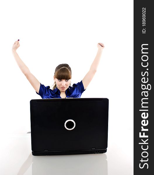 Young woman in office jubilates at desk. Isolated on white background.