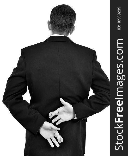 Businessman holding crossed fingers behind back isolated on white. Close-up.