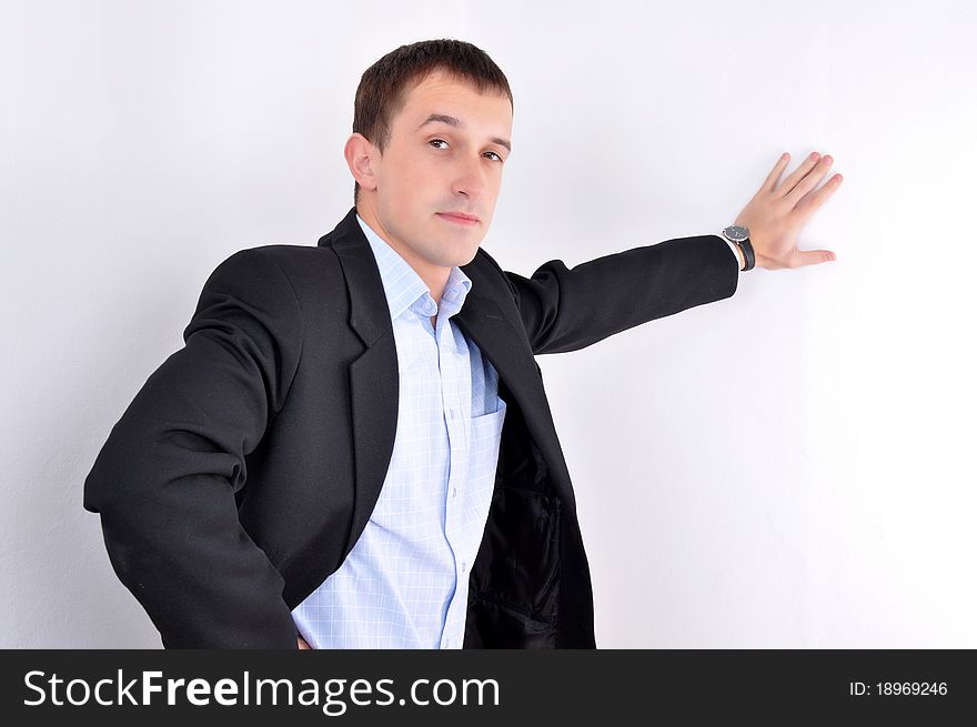 Young business Man standing at the wall