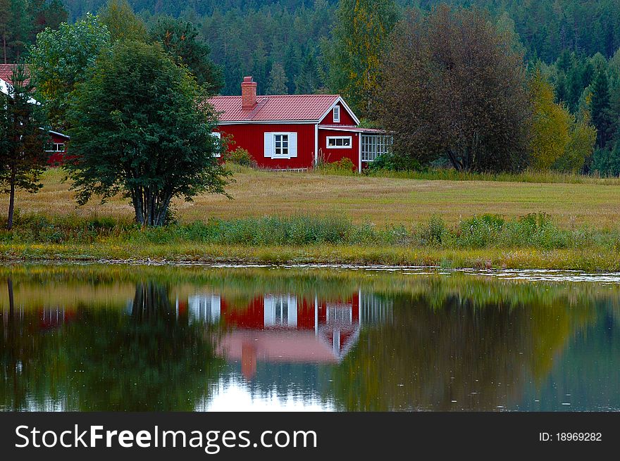 Red cabin in the woods by a lake. Red cabin in the woods by a lake