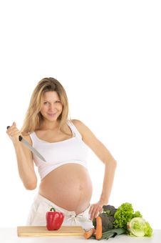 Pregnant Woman With Fruits, Vegetables And Knife Royalty Free Stock Image Pregnant Woman With Fruits, Vegetables And Knife Royalty Free Stock Image