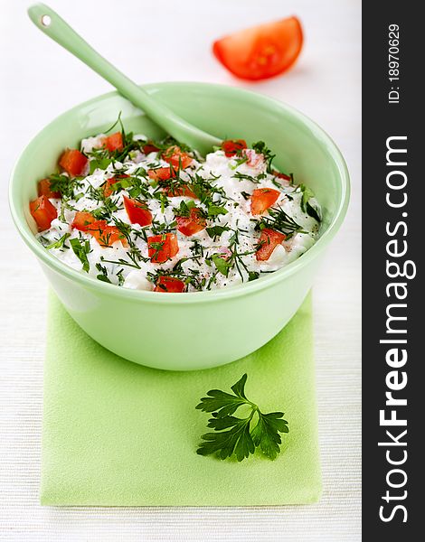 Bowl Of Curd With Tomato And Parsley