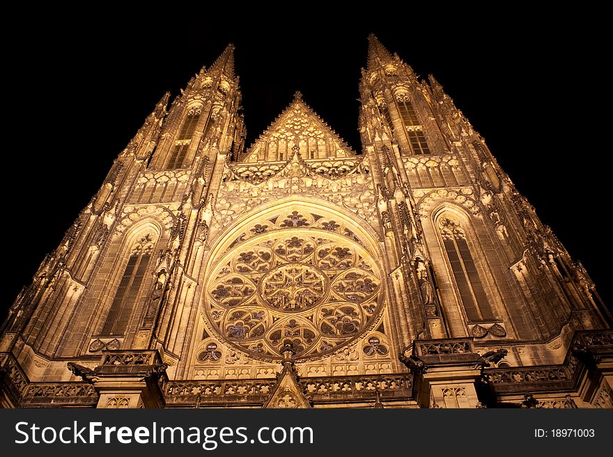 Illuminated front of saint vitus cathedral at night in Prague, Czech Republic