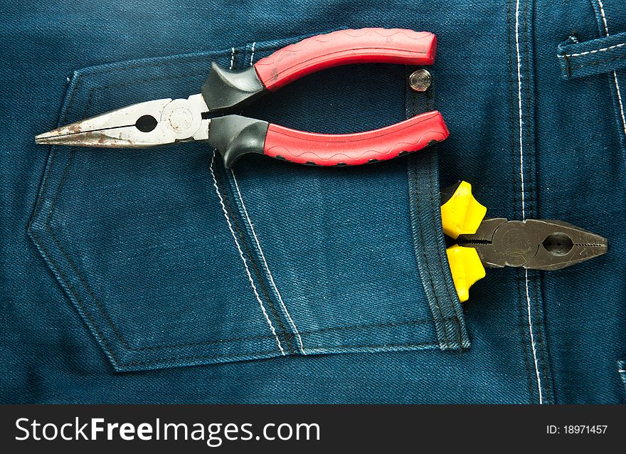 Blue jeans and tools in pocket