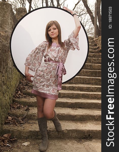 Girl posing with reflector in the park