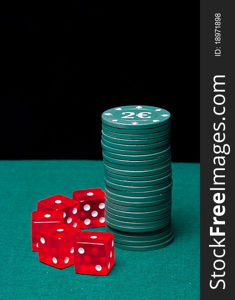 Poker Chips column with a set of dice on black background