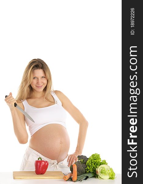 Pregnant woman with fruits, vegetables and knife isolated on white