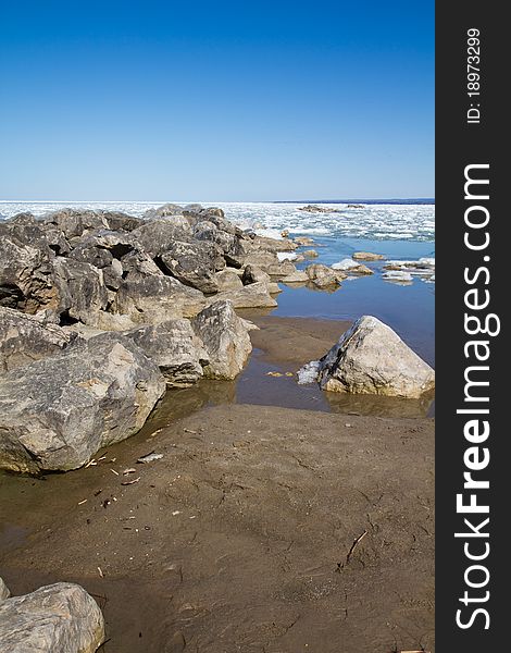 Several stone breakwall protecting a Lake Erie beach. Several stone breakwall protecting a Lake Erie beach