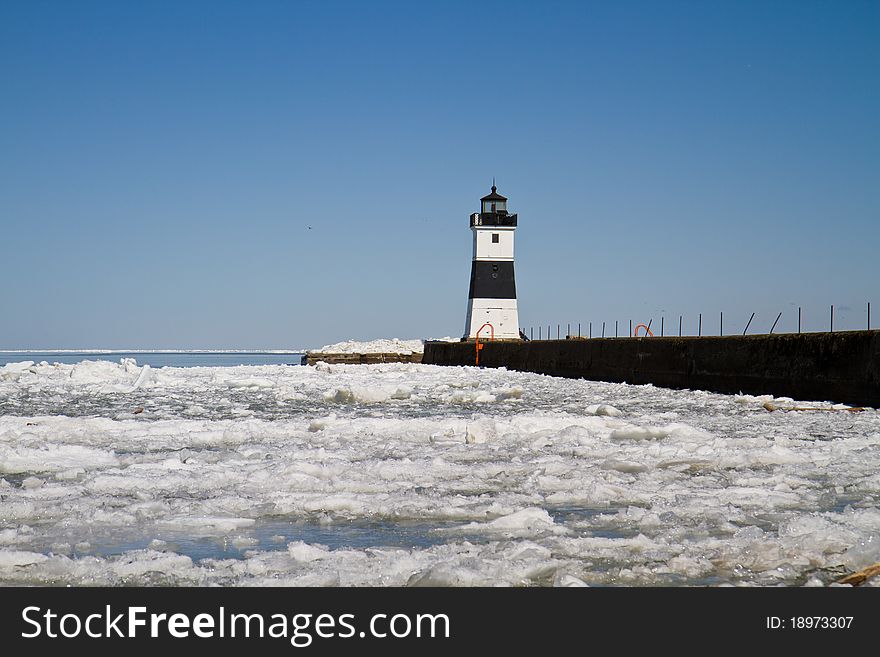 Lighthouse on Lake Erie at the end of a cement dock