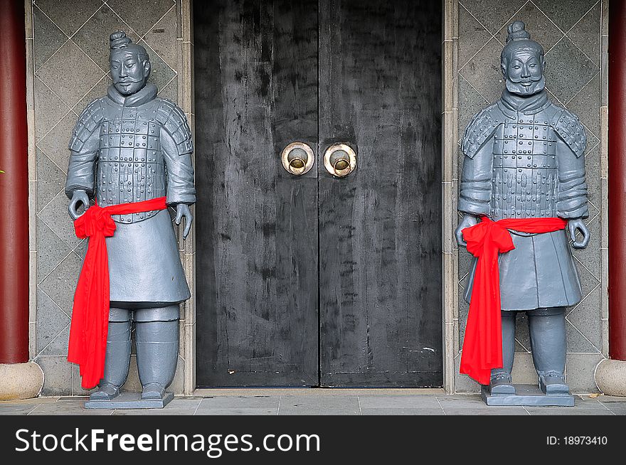 Replica Terracotta Warriors Guarding An Ancient Chinese Doorway